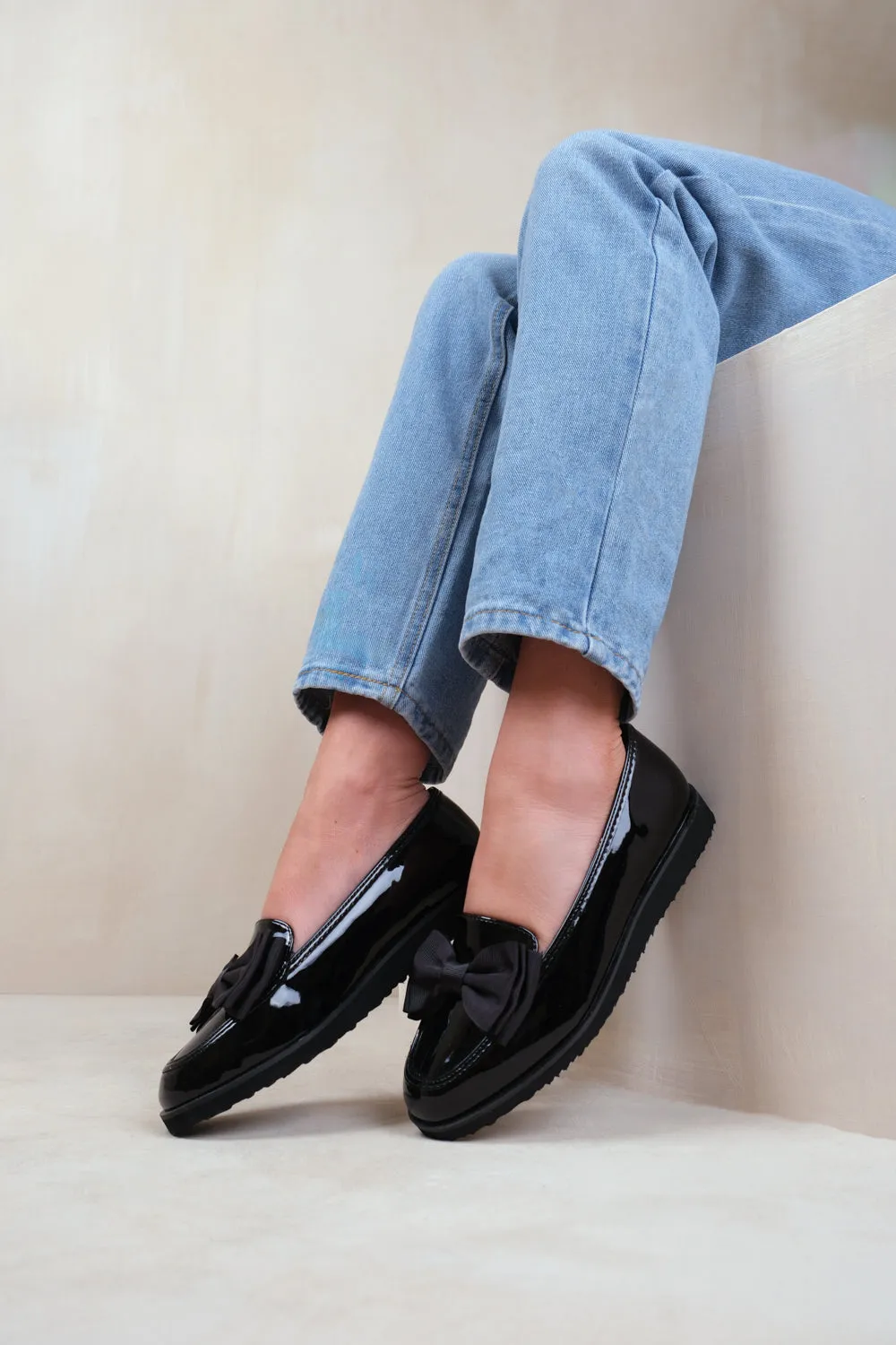 ALPHA SLIP ON LOAFER SLIDER WITH BOW DETAIL IN BLACK PATENT FAUX LEATHER